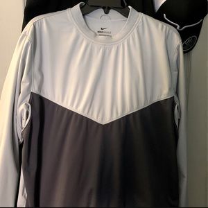 It’s a medium Nike sheild crewneck that’s a navy blue and silver blue color